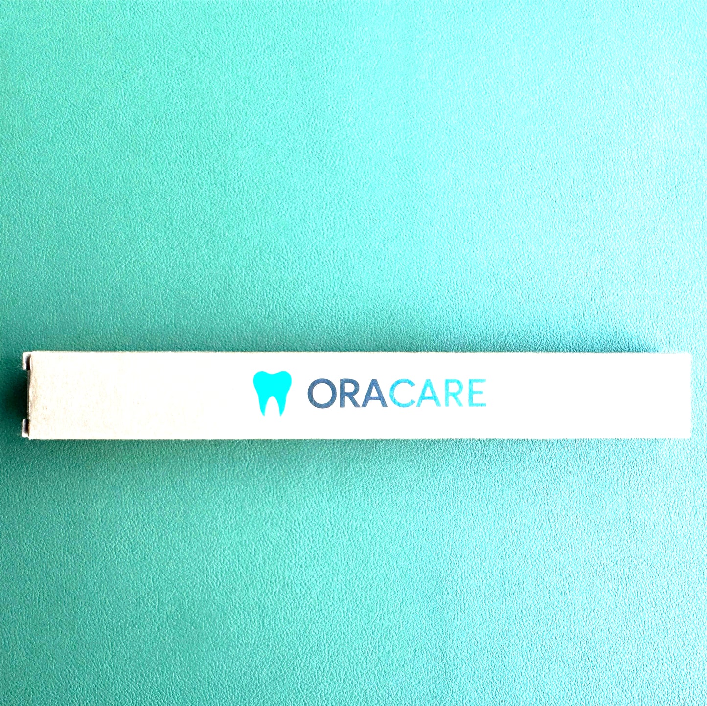 ORACARE product box on a teal background