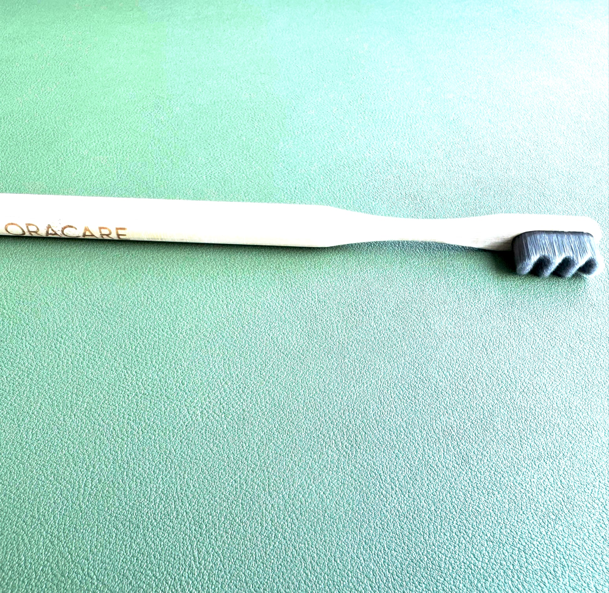 wooden toothbrush on a green background