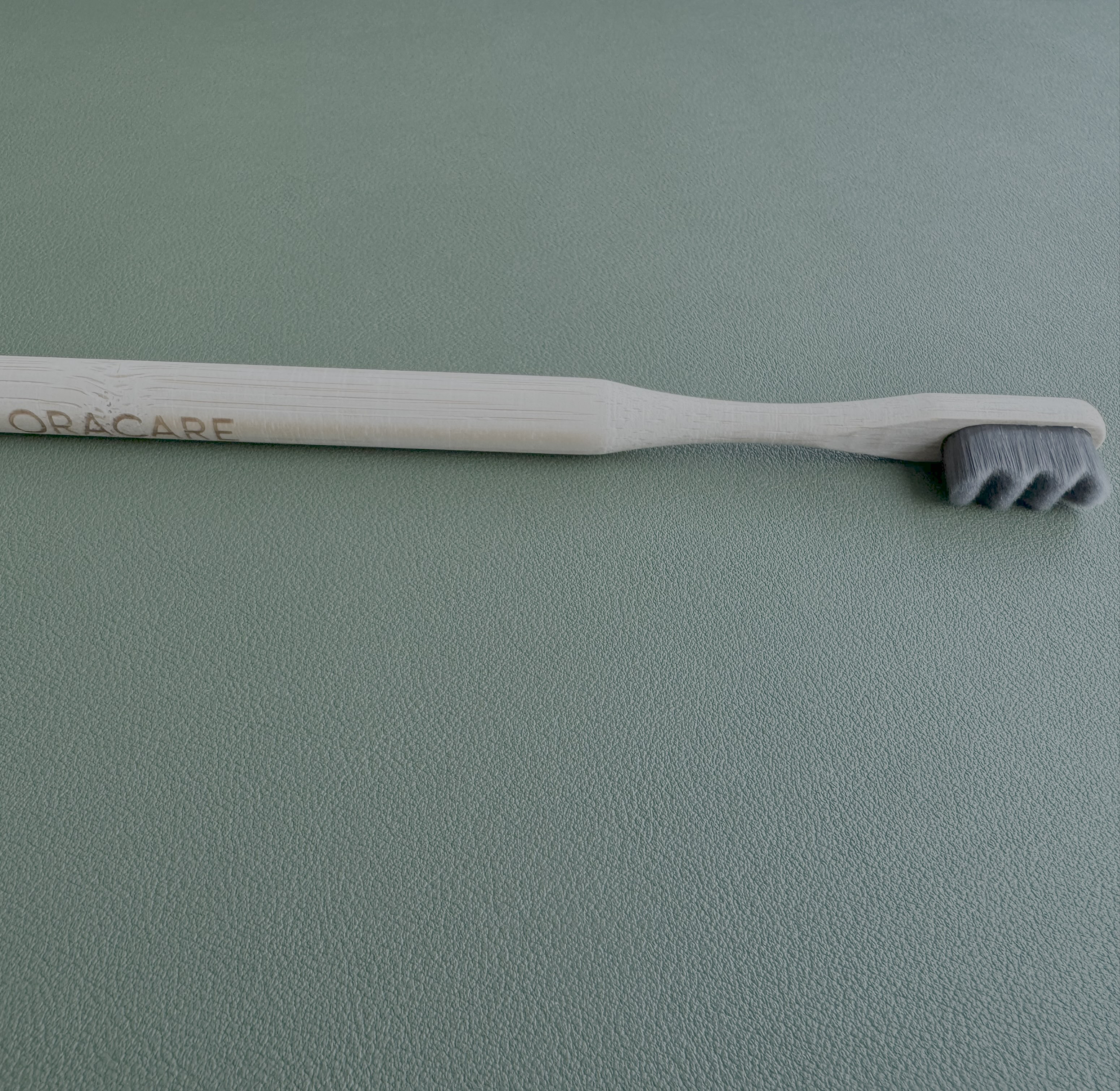 wooden toothbrush on a green background